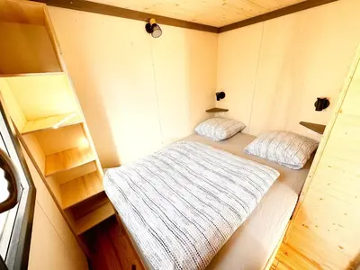 Un ou plusieurs lits dans un hébergement de l'établissement Tiny House