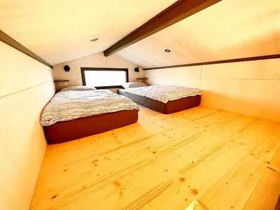 Un ou plusieurs lits dans un hébergement de l'établissement Tiny House