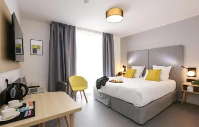 Un ou plusieurs lits dans un hébergement de l'établissement Appart'hôtel Odalys City - Angers Centre Gare