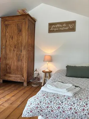 Un ou plusieurs lits dans un hébergement de l'établissement La Petite Grange - Spa Balnéo