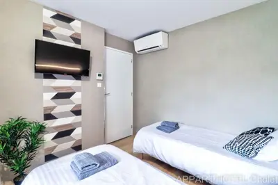 Un ou plusieurs lits dans un hébergement de l'établissement Appart hotel Cholet Carteron