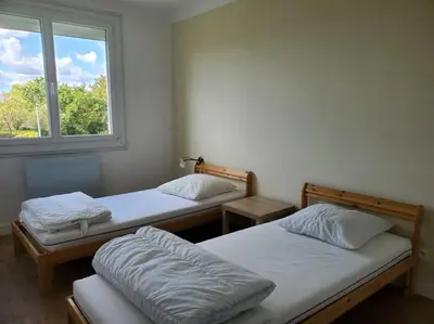 Un ou plusieurs lits dans un hébergement de l'établissement Maison du Domaine (Gîte)