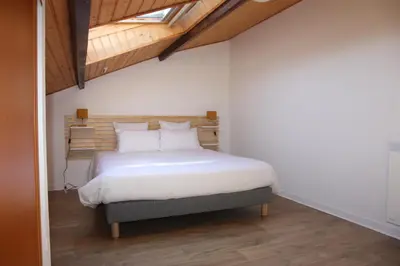 Un ou plusieurs lits dans un hébergement de l'établissement Résid'Spa Loire & Sèvre - Appartement