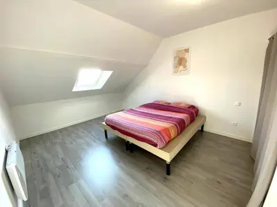 Un ou plusieurs lits dans un hébergement de l'établissement Appartement 2chambres/PuyDuFou
