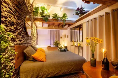 Un ou plusieurs lits dans un hébergement de l'établissement LOVE ROOM JUNGLE - LES PETITS PLAISIRS