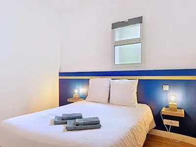 Un ou plusieurs lits dans un hébergement de l'établissement Appartement Le Porto