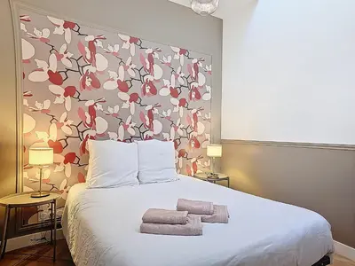Un ou plusieurs lits dans un hébergement de l'établissement Appartement Le Bd Haussmann, chic & raffiné !