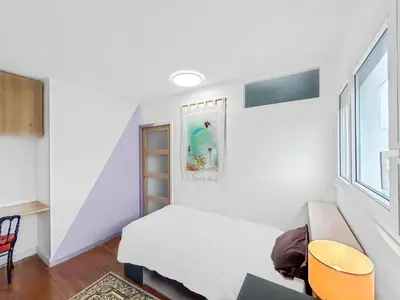 Un ou plusieurs lits dans un hébergement de l'établissement Maison charmante à Saint-Herblain avec jardin privé