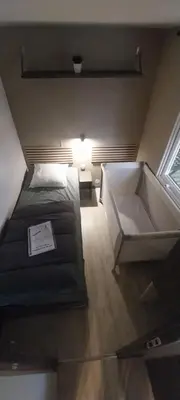 Un ou plusieurs lits dans un hébergement de l'établissement Mobilhome cosy Aulywan