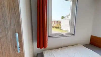 Un ou plusieurs lits dans un hébergement de l'établissement Mobil Home avec Clim La Plage