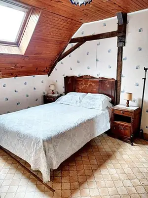 Un ou plusieurs lits dans un hébergement de l'établissement Maison charmante à Ombrée d'Anjou avec jardin et terrasse