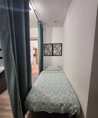 Un ou plusieurs lits dans un hébergement de l'établissement La petite loge de l'ile