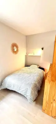 Un ou plusieurs lits dans un hébergement de l'établissement Évasion, Studio Cosy près de la Plage
