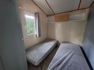 Un ou plusieurs lits dans un hébergement de l'établissement Camping L'AMBOIS