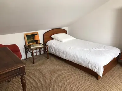 Un ou plusieurs lits dans un hébergement de l'établissement Petite maison cosy