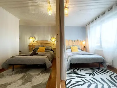 Un ou plusieurs lits dans un hébergement de l'établissement Le Nid Douillet - Duplex Bois & Charme