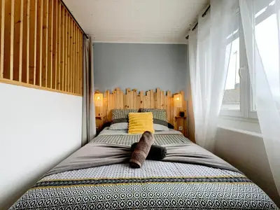 Un ou plusieurs lits dans un hébergement de l'établissement Le Nid Douillet - Duplex Bois & Charme