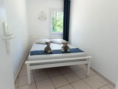 Un ou plusieurs lits dans un hébergement de l'établissement Maison 2 chambres