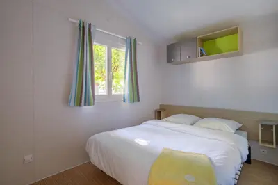 Un ou plusieurs lits dans un hébergement de l'établissement Camping Ushuaïa Villages Le Parc de la Grève