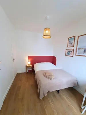 Un ou plusieurs lits dans un hébergement de l'établissement Joli appartement à Paimboeuf