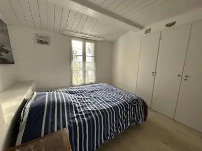 Un ou plusieurs lits dans un hébergement de l'établissement Maison de vacances 6 pers avec piscine à La Guérinière - FR-1-224B-240
