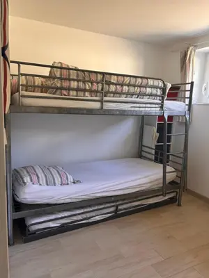 Un ou plusieurs lits dans un hébergement de l'établissement Maison Familiale Chaleureuse à Deux Pas de la Plage