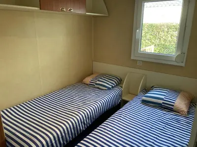Un ou plusieurs lits dans un hébergement de l'établissement Mobile home