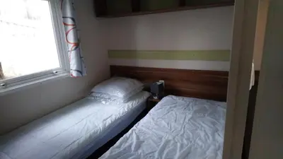 Un ou plusieurs lits dans un hébergement de l'établissement Mobil home camping 4 étoile