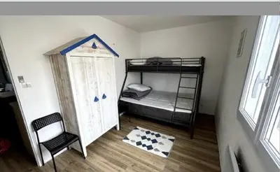 Un ou plusieurs lits dans un hébergement de l'établissement appartement au bord de l'océan