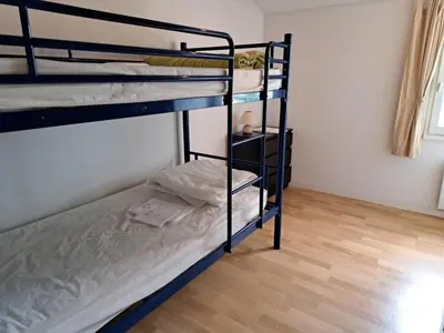 Un ou plusieurs lits dans un hébergement de l'établissement Maison familiale charmante avec piscine privée et parking à Saint-Jean-de-Monts - FR-1-323-576
