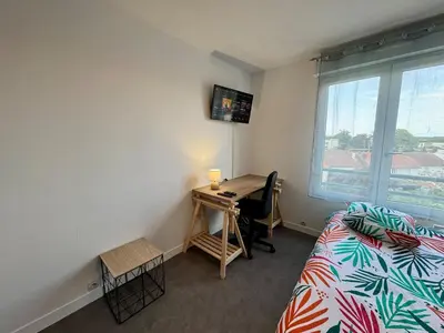 Un ou plusieurs lits dans un hébergement de l'établissement Appartement Cosy dans le Centre