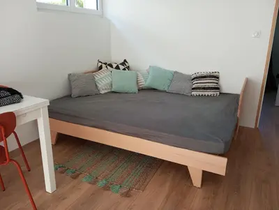 Un ou plusieurs lits dans un hébergement de l'établissement L'Olivier, appartement cosy entre mer et forêt