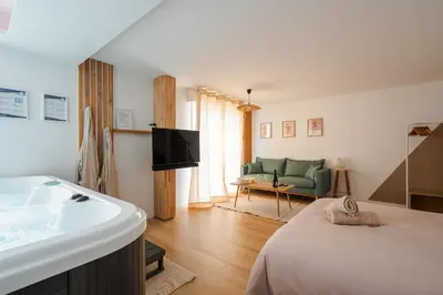 Un ou plusieurs lits dans un hébergement de l'établissement La Parenthèse Gemmoise avec jacuzzi privatif