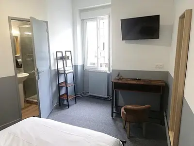 Un ou plusieurs lits dans un hébergement de l'établissement hôtel BEAUTOUR