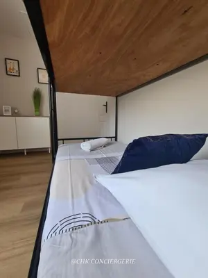 Un ou plusieurs lits dans un hébergement de l'établissement Maison du Puy avec jardin clos, 4 min Puy duFou
