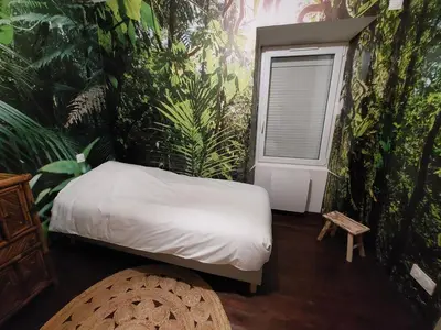 Un ou plusieurs lits dans un hébergement de l'établissement La Tropi'kaz - Jungle room