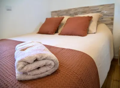 Un ou plusieurs lits dans un hébergement de l'établissement Les Dunes, cosy et chaleureux