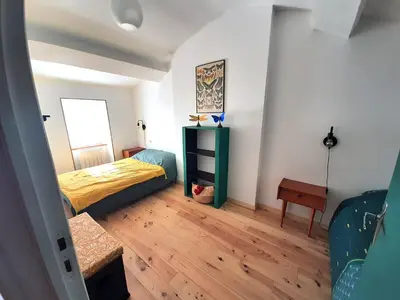 Un ou plusieurs lits dans un hébergement de l'établissement Charmante maison