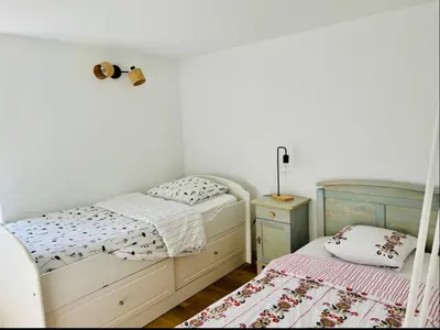 Un ou plusieurs lits dans un hébergement de l'établissement Charmante maison avec jardin dans le cœur de Savennières