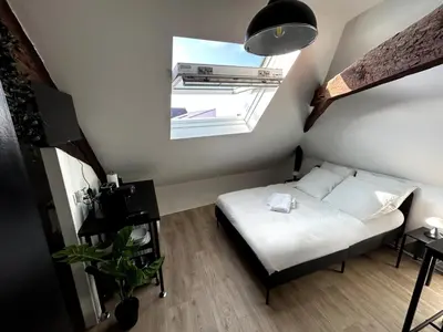 Un ou plusieurs lits dans un hébergement de l'établissement Le Studio - Cosy et fonctionnel - plein centre