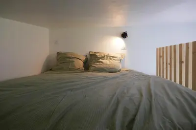 Un ou plusieurs lits dans un hébergement de l'établissement Studio bois indépendant aux portes de Nantes