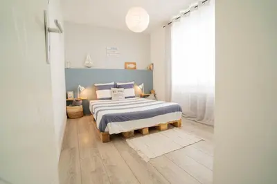 Un ou plusieurs lits dans un hébergement de l'établissement Maison avec fauteuil suspendu et lit de jour près de la mer en Vendée