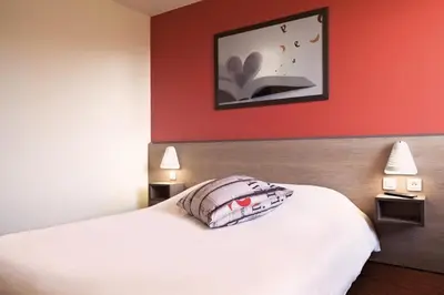 Un ou plusieurs lits dans un hébergement de l'établissement Ace Hôtel Angers