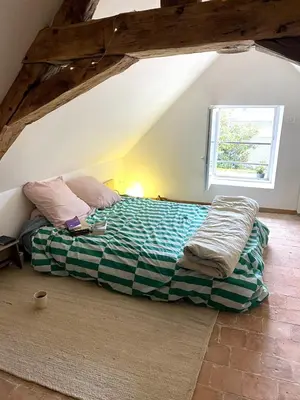 Un ou plusieurs lits dans un hébergement de l'établissement Joli maison de bourg