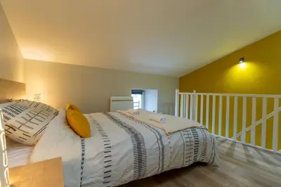 Un ou plusieurs lits dans un hébergement de l'établissement Aramis Appartement cosy à 15 min du Puy Du Fouu