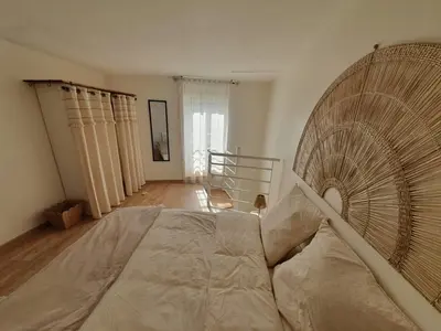 Un ou plusieurs lits dans un hébergement de l'établissement Les Cotonniers, duplex cosy