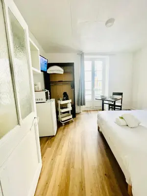 Un ou plusieurs lits dans un hébergement de l'établissement Apparthotel Beauregard 12 cœur de Nantes WIFI