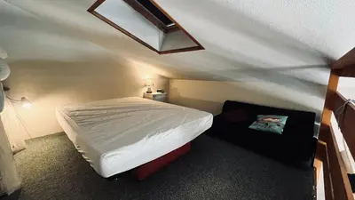 Un ou plusieurs lits dans un hébergement de l'établissement Les Fermettes, appartement lumière