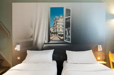 Un ou plusieurs lits dans un hébergement de l'établissement B&B HOTEL Angers 1 Beaucouzé