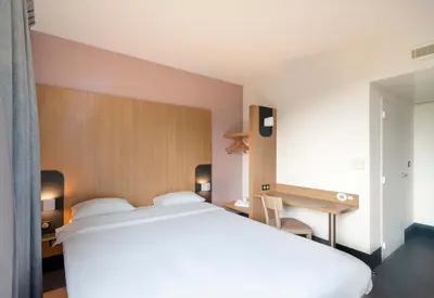 Un ou plusieurs lits dans un hébergement de l'établissement B&B HOTEL Nantes Savenay